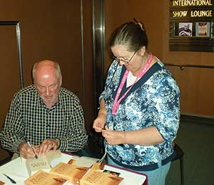 Frank signs copies of The Last Maasai Warrior after his lecture attended by around two hundred readers on board the Pacific Dawn